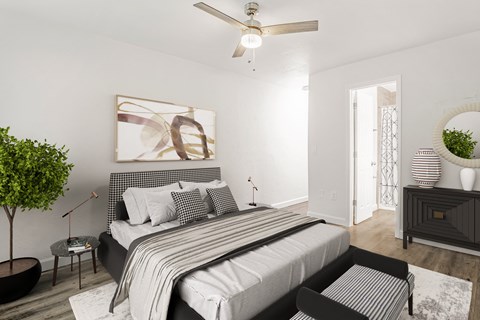 Pet-friendly bedroom featuring a bed and ceiling fan at Addison Lane Apartment Homes in Gainesville, Florida