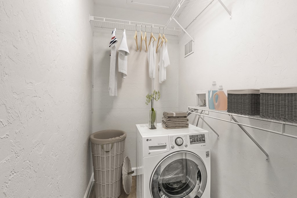 Addison Lane Apartment homes in Gainesville Florida photo of a small laundry room with a washing machine and dryer
