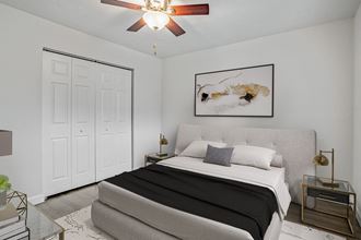 Addison Lane Apartment homes in Gainesville Florida photo of a bedroom with white walls and a ceiling fan - Photo Gallery