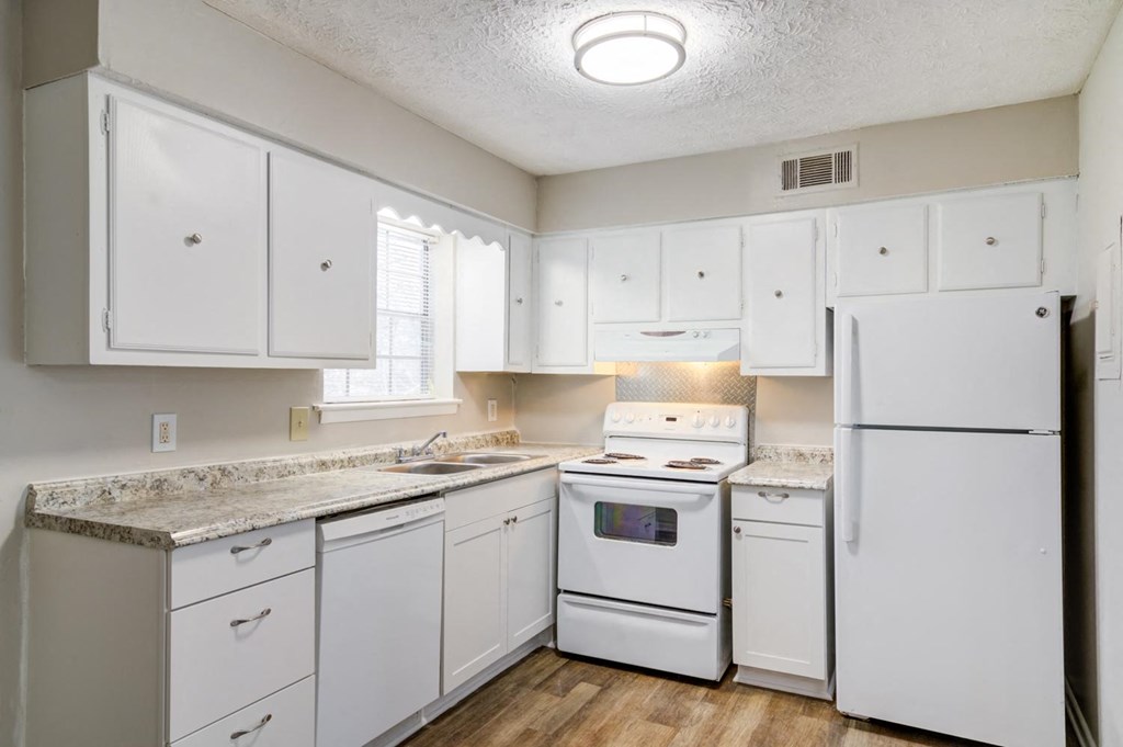 Affinitee at Pine Lake Apartments in Pine Lake, GA photo of a white kitchen with white appliances and white cabinets