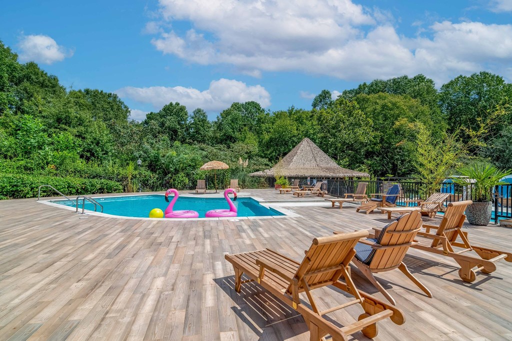 Affinitee at Stone Mountain Apartments photo of a swimming pool with deck chairs around it