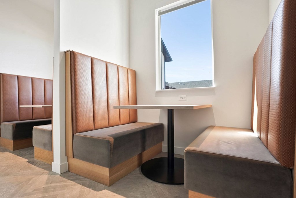 a small table and two chairs in a room with a window