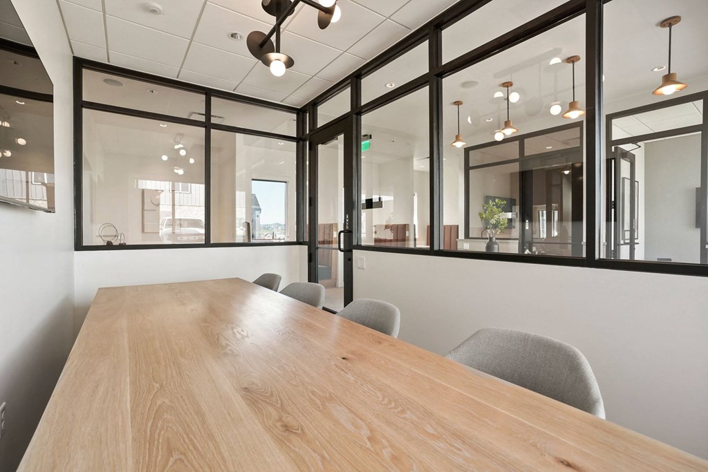 a conference room with large windows and a wooden table