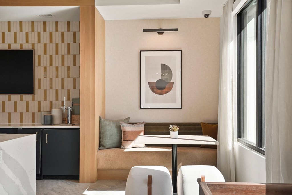 a living room with a couch and a table in front of a window