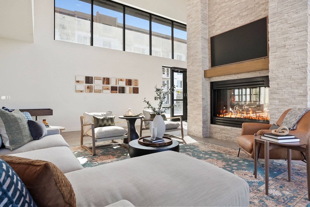 a living room filled with furniture and a large fireplace