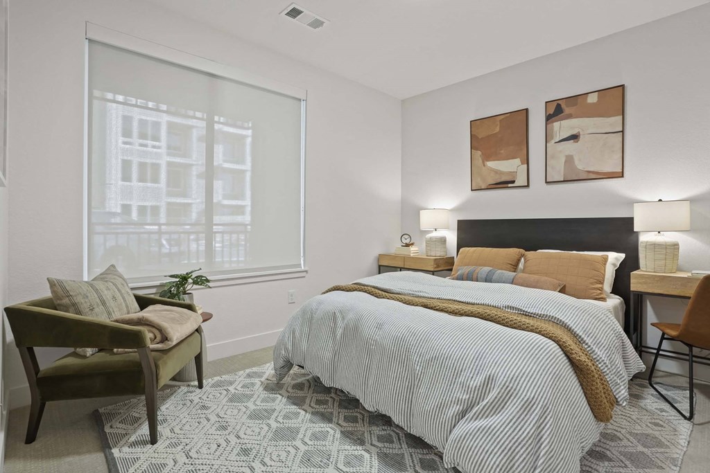 a bedroom with a bed and a large window