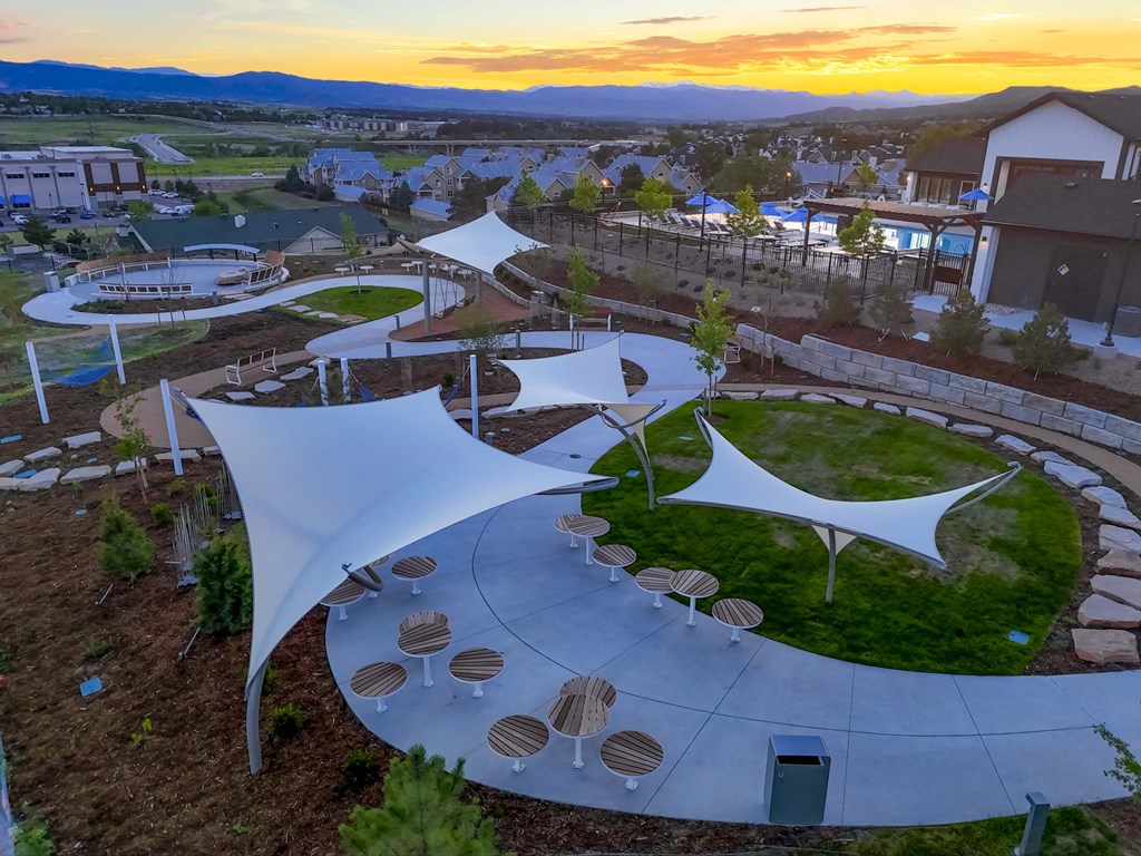an aerial view of a park with shade structures