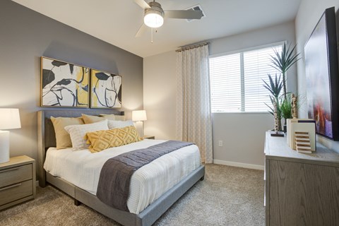 a bedroom with a bed and a ceiling fan