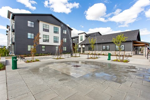 A modern building complex with a spacious courtyard.