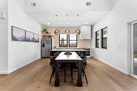 A modern dining room with a wooden table and chairs.