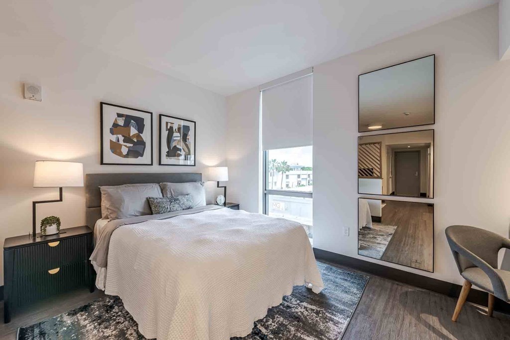 Well-lit and spacious bedroom in a pet-friendly Miami Beach apartment, featuring large windows that bring in natural light and create an airy, inviting atmosphere.