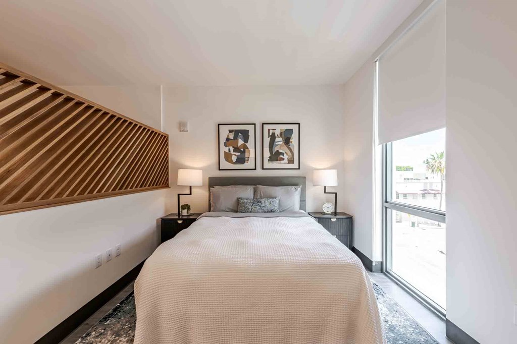 Bright bedroom in a Miami Beach pet-friendly apartment featuring large windows, neutral tones, and spacious layout for comfortable urban living.