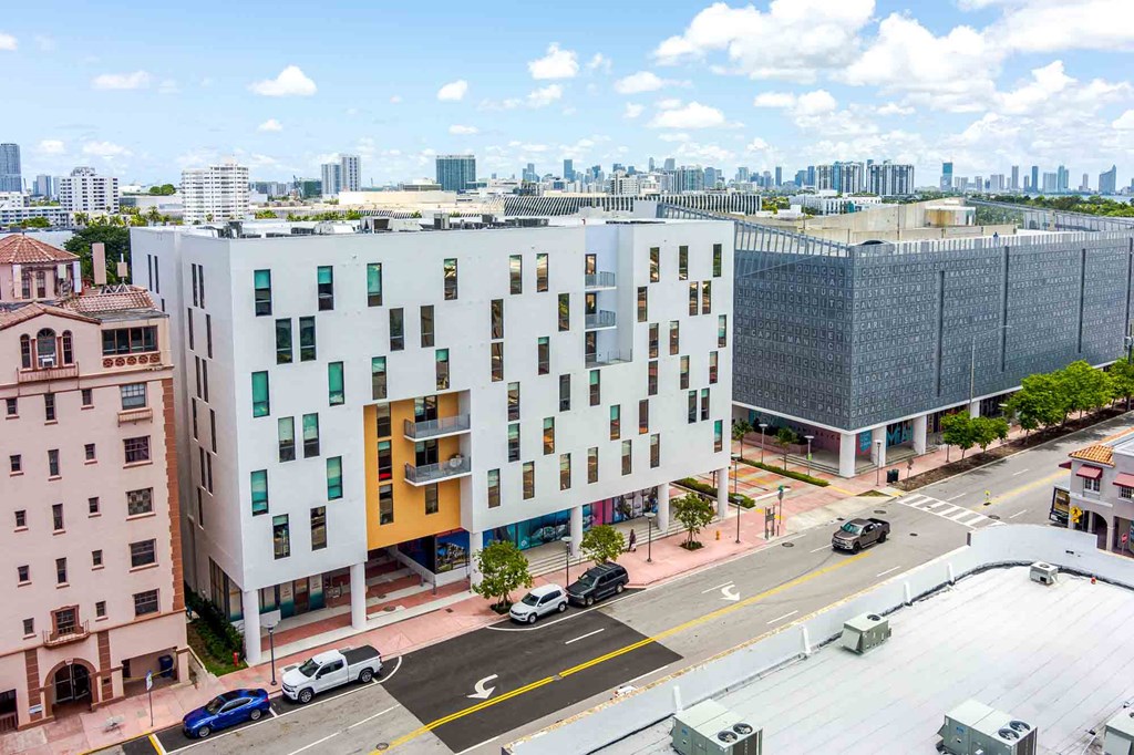 Aerial view of a modern pet-friendly apartment building in Miami Beach, showcasing sleek architecture and urban surroundings.