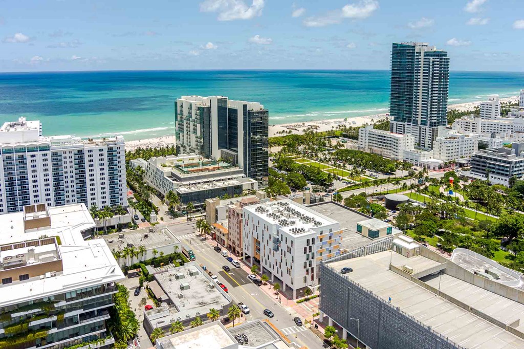 A cityscape with buildings and a beach in the background.