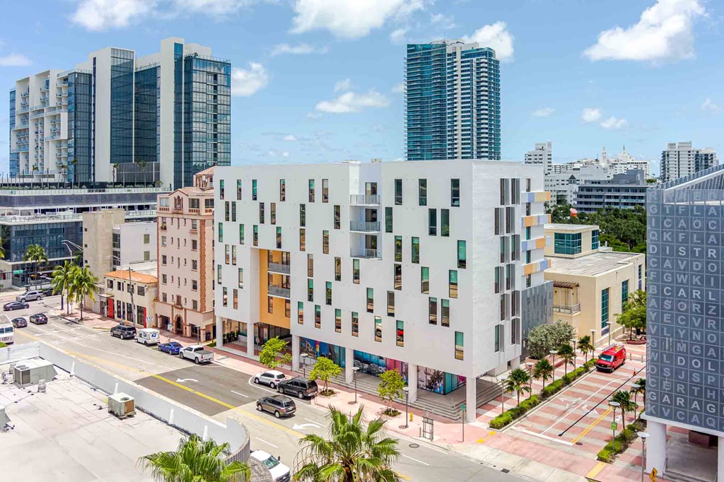 Aerial view of a pet-friendly Miami Beach apartment community showcasing modern buildings and city surroundings.