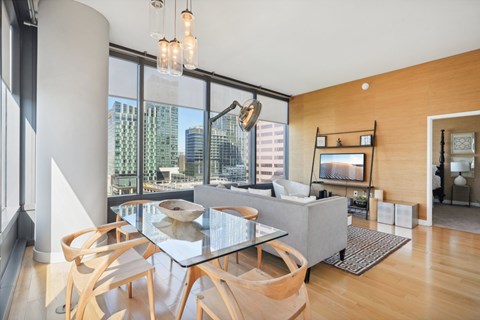A modern dining room with a glass table and chairs.