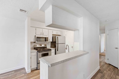 a kitchen with white appliances and a counter top