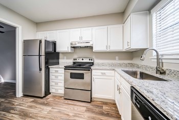 Renovated kitchen with stainless steel appliances and stone counter tops ( 1 and 2 bedroom townhomes) - Photo Gallery 3