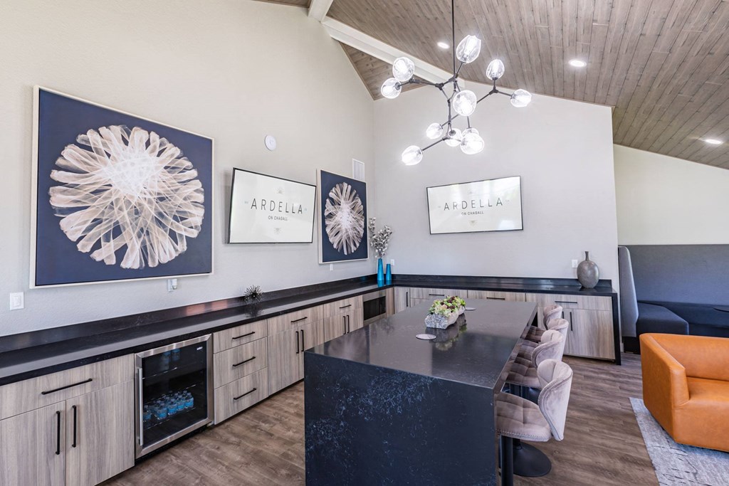 a kitchen with a black counter top and a dining table