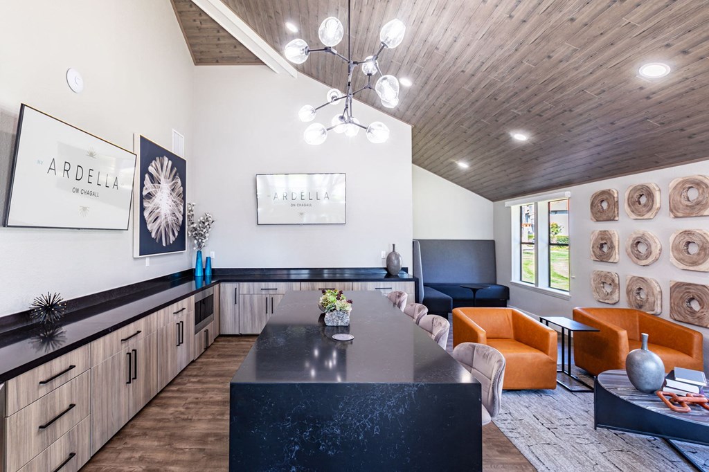 a kitchen and living room with a table and chairs