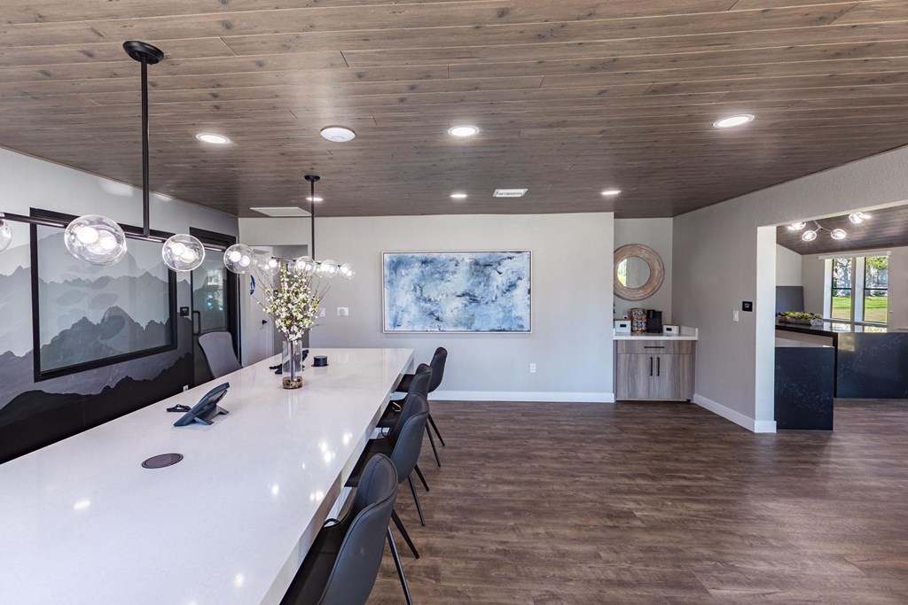 a long dining room with a long table and chairs