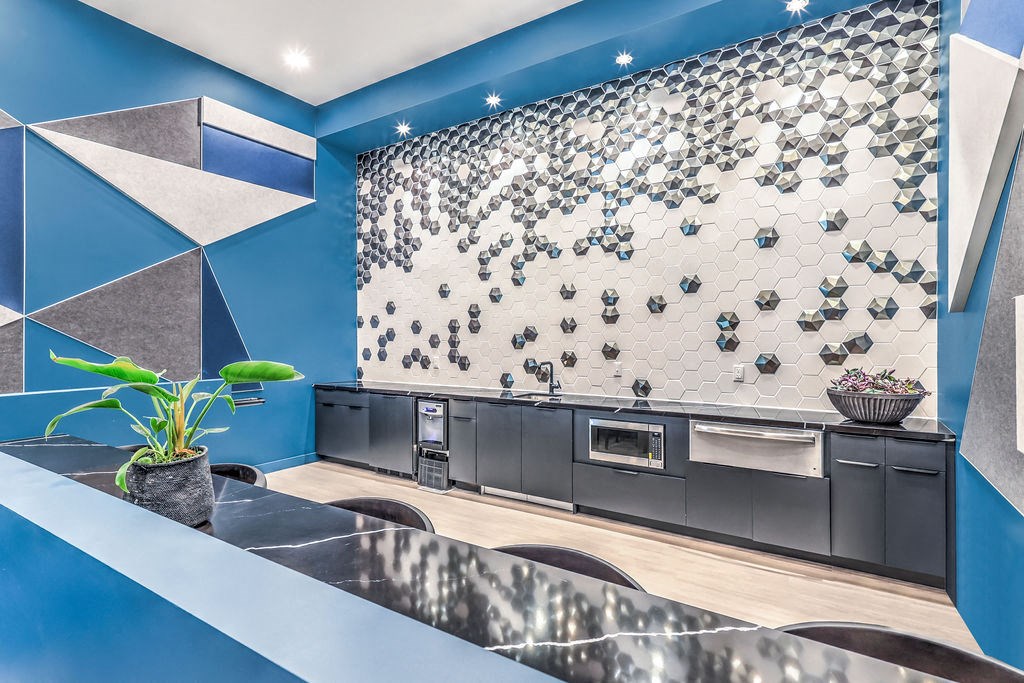 a kitchen with blue walls and white countertops