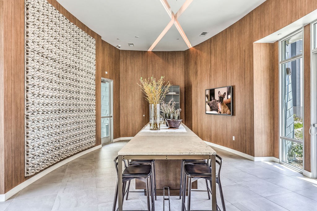 a dining room with wood walls and a white ceiling