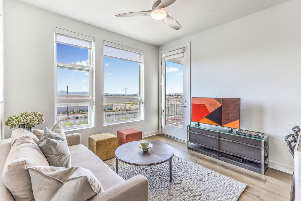 a living room with a couch coffee table and a tv