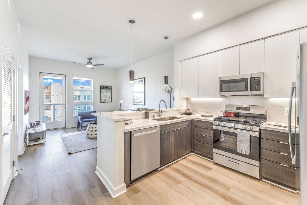 a kitchen with white cabinetry and a wooden floor