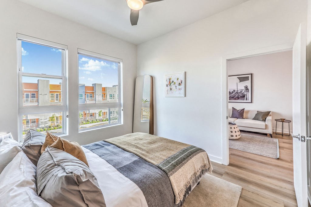 a bedroom with a large bed and three windows