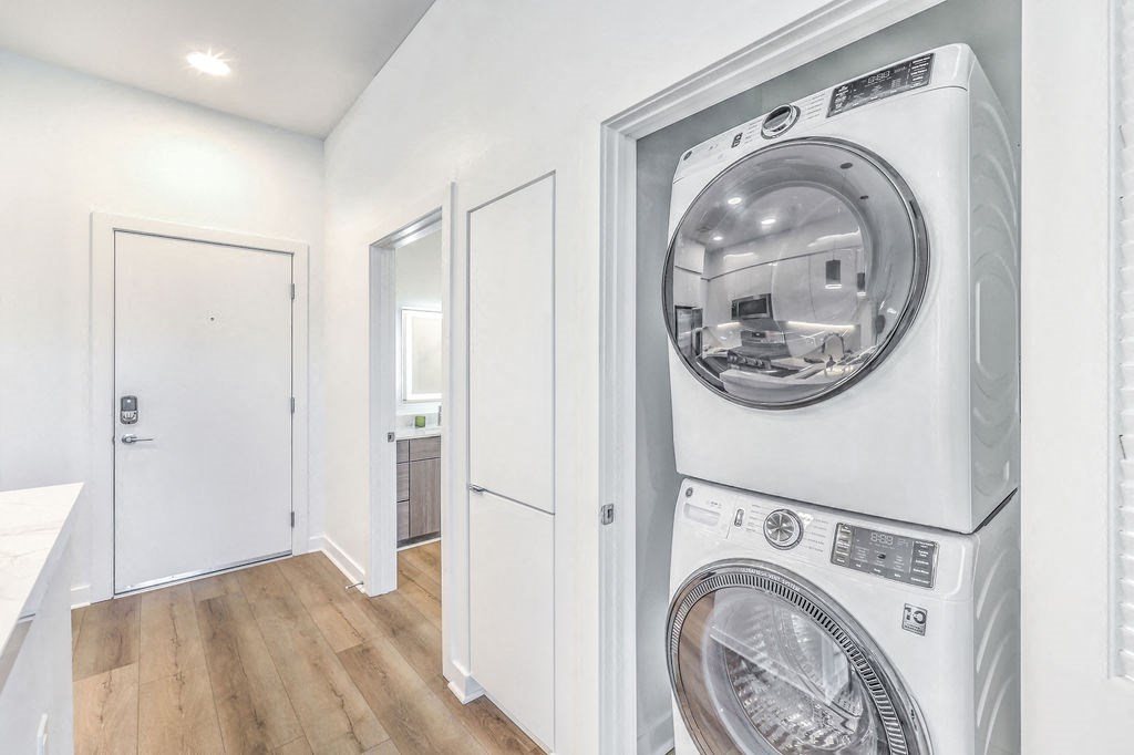 a white washer and dryer in a white laundry room