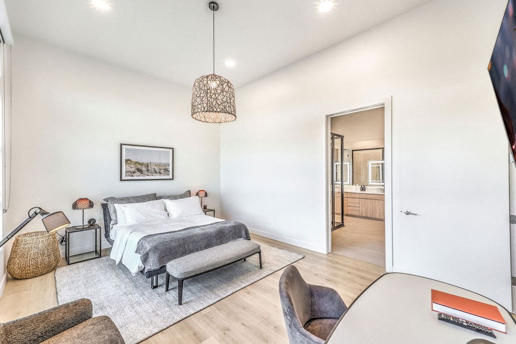 a bedroom with a bed and a chair in a 555 waverly unit