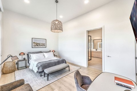 a bedroom with a bed and a chair in a 555 waverly unit