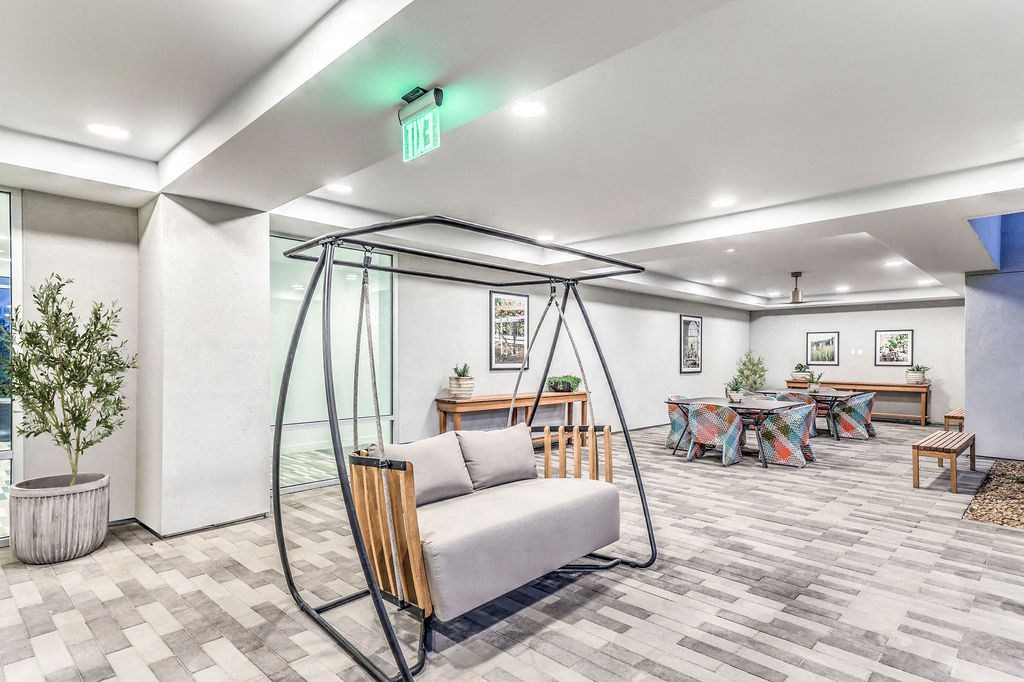 a swing chair in the lobby of a building