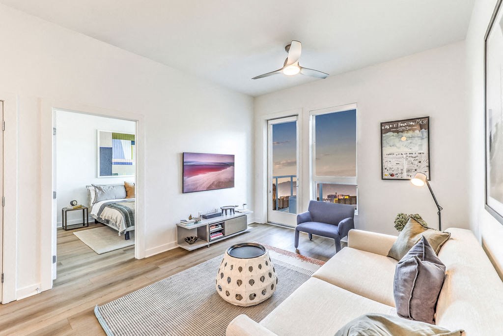 a living room with white walls and hardwood floors