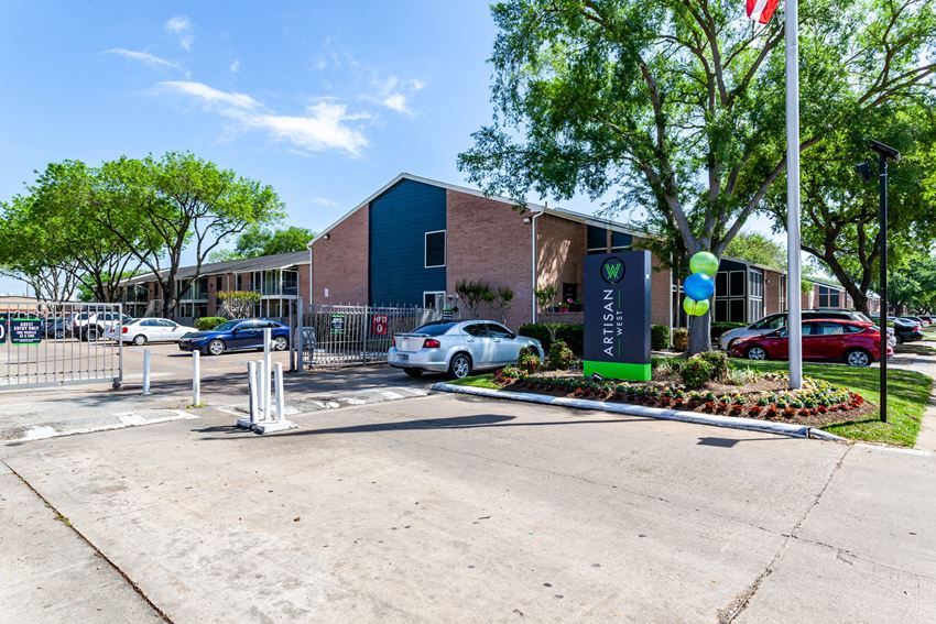 a parking lot in front of a building with cars parked in front