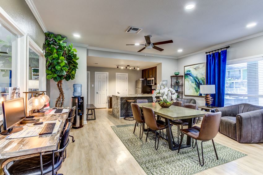 a living room and dining room with a table and chairs