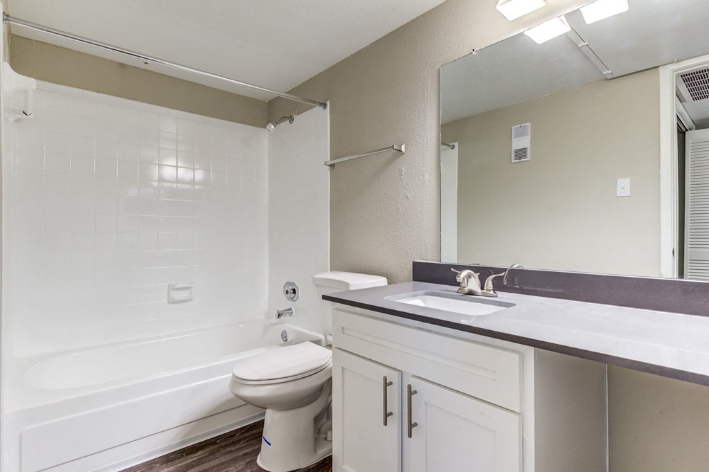 an empty bathroom with a sink toilet and shower