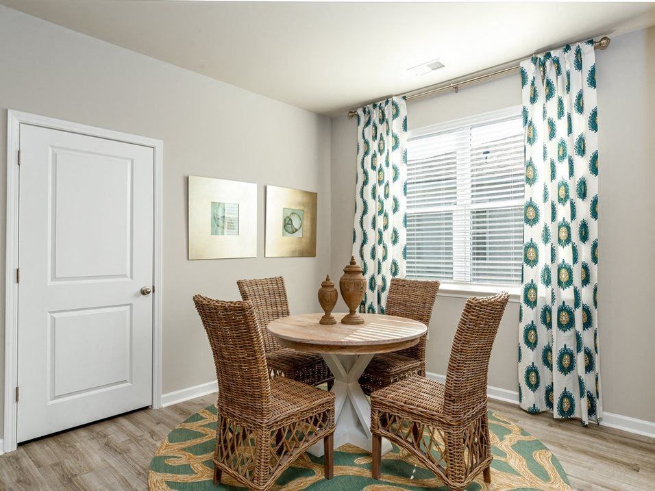 a dining room with a table and four chairs