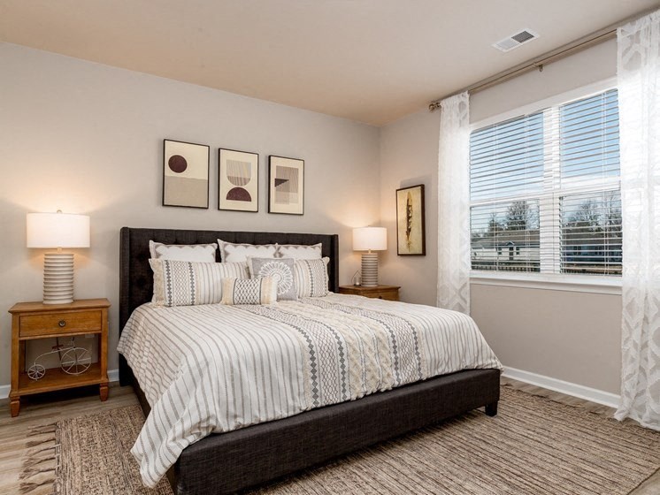 a bedroom with a large bed and a large window