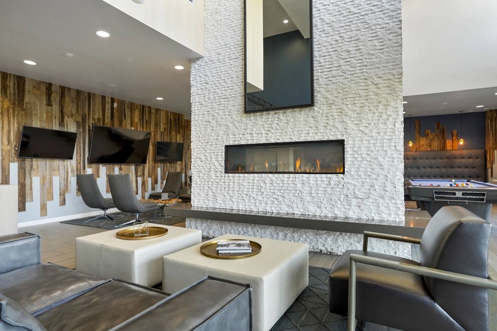 a living room with couches and chairs and a fireplace