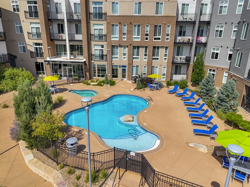 an aerial view of an apartment building with a swimming pool