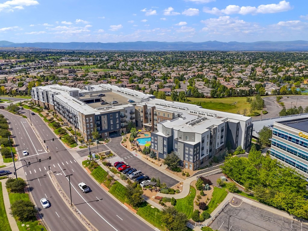 an aerial view of a city with buildings and a swimming pool