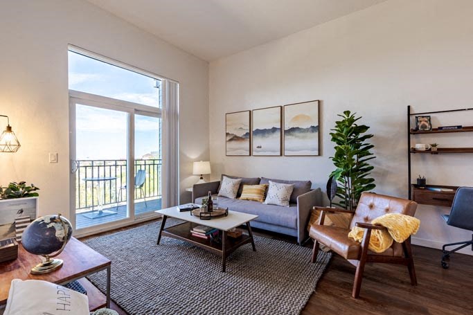 a living room with a couch and a sliding glass door
