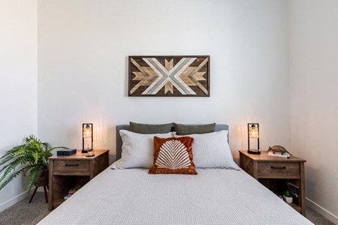 a bedroom with a bed and a painting on the wall