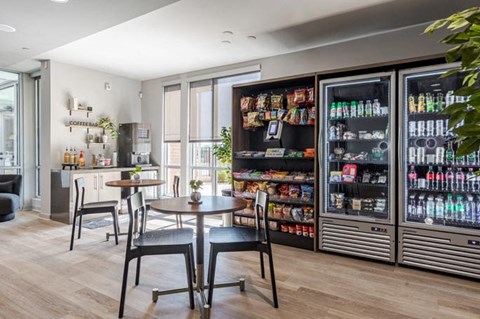 a dining room with a table and chairs in front of a refrigerator