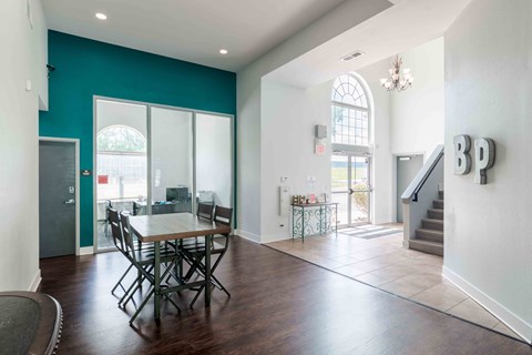 a dining room with a table and chairs and a staircase