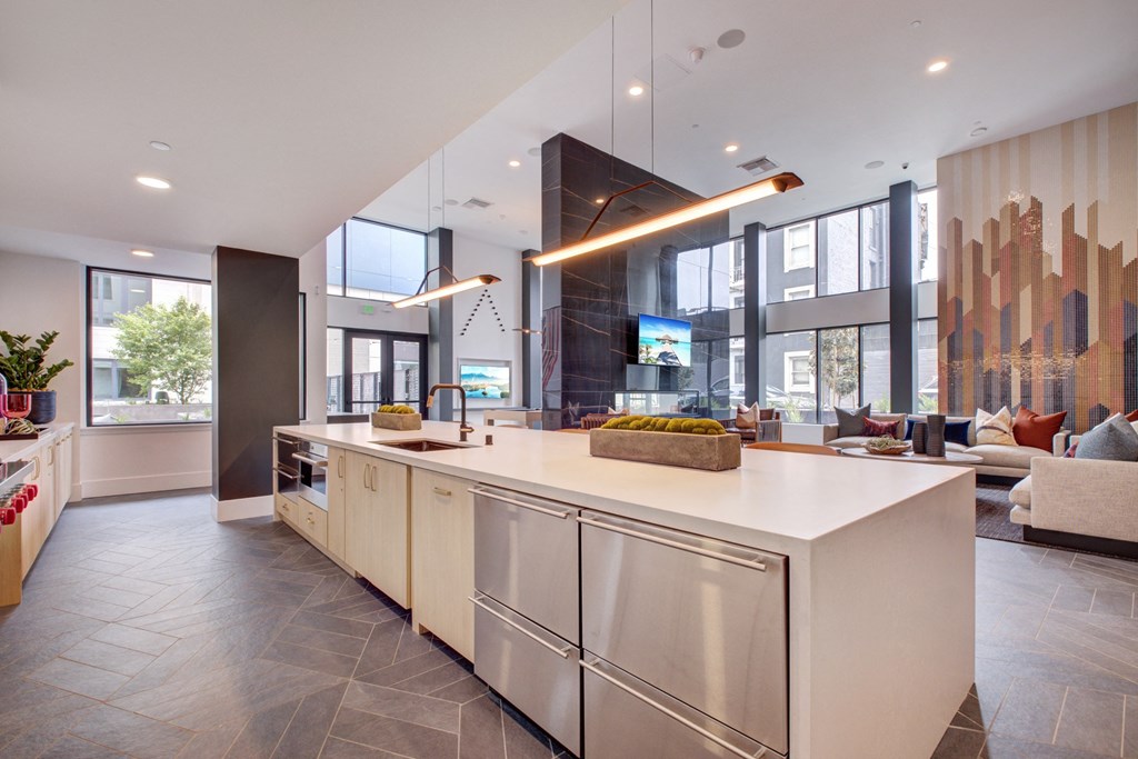 a large kitchen with an island and a living room