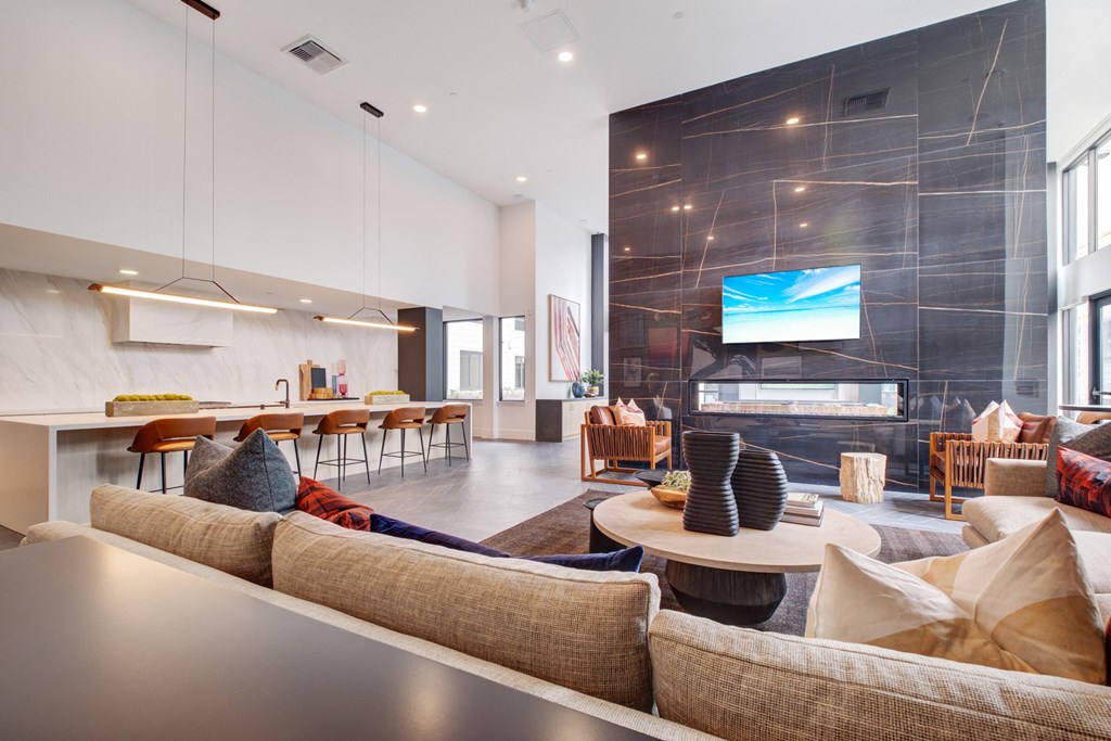 a living room with couches and a table and a fireplace