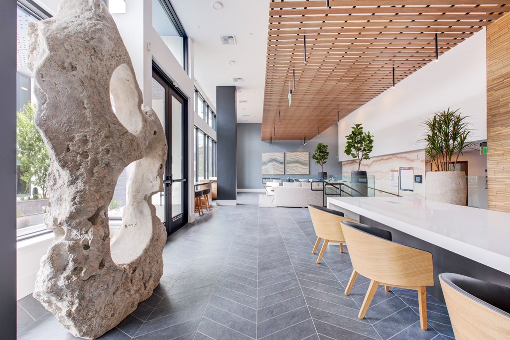 a large rock in the middle of a room with a table and chairs